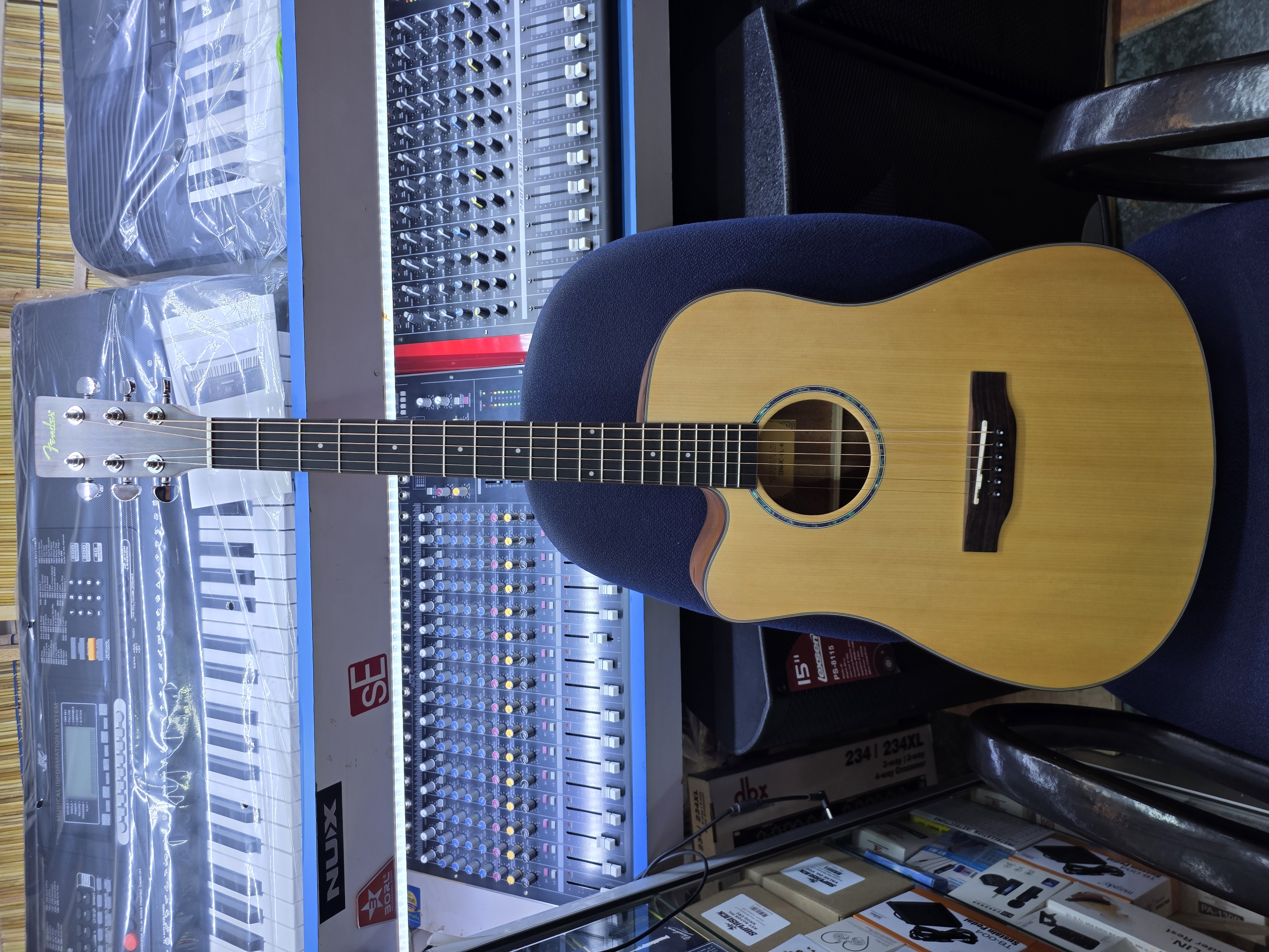 Maxtone 41-inch left-handed semi-acoustic guitar with cutaway body, built-in EQ pickup system, and natural wood finish.